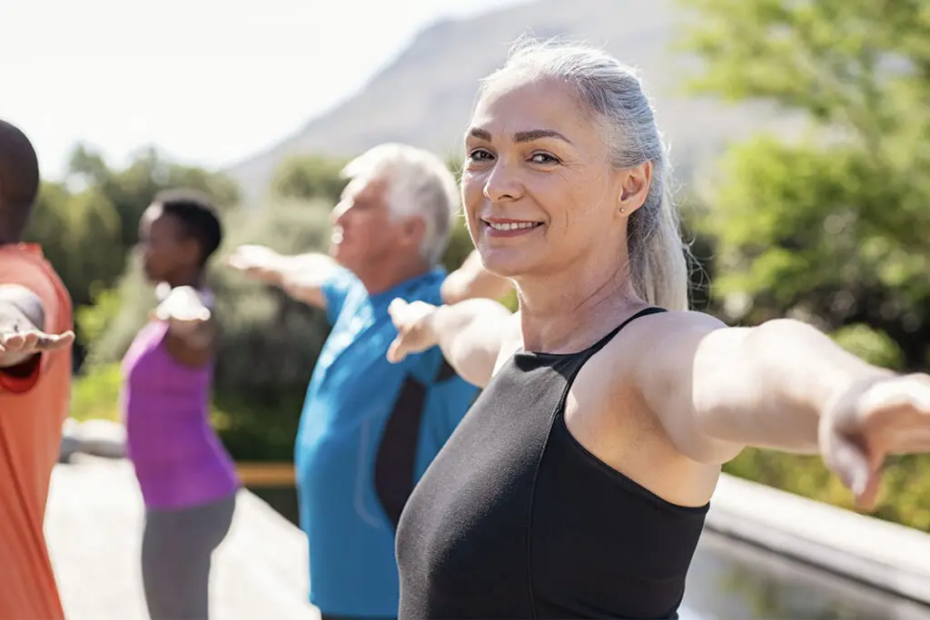 Active adults in stretch class — peptides for recovery, performance, and longevity