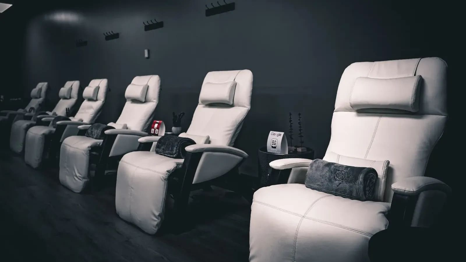 White reclining infusion chairs in a row in the Alpha IV Therapy lounge in South Tulsa