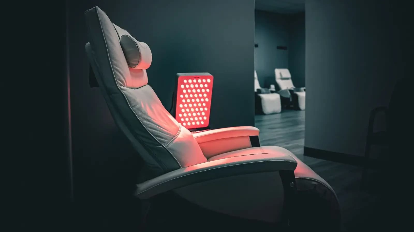 Infusion recliner beside a red-light panel at Alpha IV Therapy